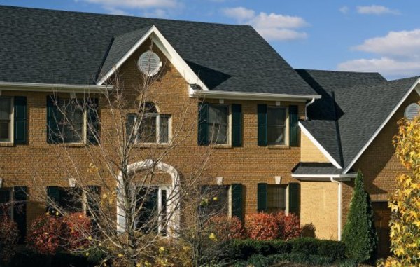 Brick front home with white trim and gutters.